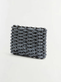 Angled view of the SIMKHAI Morgan Woven Rhinestone Clutch in Black showing its woven rhinestone texture.