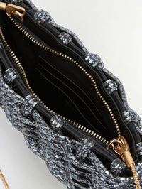 Interior detail of the SIMKHAI Morgan Woven Rhinestone Clutch in Black with zip top and card slots.