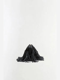 Side view of the SIMKHAI Pia Beaded Fringe Clutch in Black with beaded fringe falling past the frame.