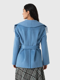 Back view of the SIMKHAI Rowen Fringe Jacket in Dusty Blue showing the wide collar and tie belt.