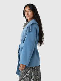 Side view of the SIMKHAI Rowen Fringe Jacket in Dusty Blue with fringe falling over the shoulder.
