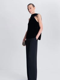 Three quarter view of the SIMKHAI Scarlett Draped Velvet Cape Top in Black showing the side drape.