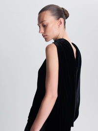 Side back detail of the velvet cape drape on the SIMKHAI Scarlett Draped Velvet Cape Top in Black.