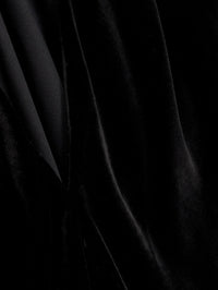 Close up of the black viscose and silk velvet folds on the SIMKHAI Scarlett Draped Velvet Cape Top.