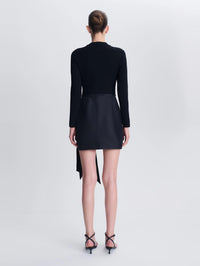 Back view of the SIMKHAI Tedda Taffeta Knit Mini Dress in Black with the sash tail at the side.