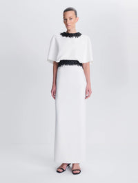 Front view of a model in the SIMKHAI Vantrel Short Sleeve Gown in Ivory showing the cape bodice and column skirt.