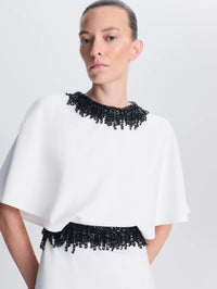 Close-up of the cape bodice and beaded neckline on the SIMKHAI Vantrel Short Sleeve Gown in Ivory.