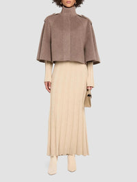 Full length styled view of the SIMKHAI Yara Cape Jacket in Mushroom Melange over a ribbed knit dress.