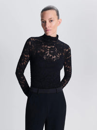 Close front view of the SIMKHAI Zurie Lace Bodysuit in Black with sheer floral lace sleeves and high neck.