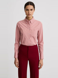 Front view of the SMYTHE Button Down Shirt in Vintage Rose tucked into red trousers