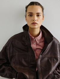 Styled view of the SMYTHE Button Down Shirt in Vintage Rose under a brown leather bomber jacket