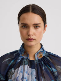 Close-up of the stand-up collar and gathers on the SMYTHE Gathered Blouse in Navy Floral.