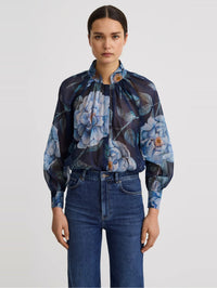 Front view of the SMYTHE Gathered Blouse in Navy Floral tucked into blue jeans.