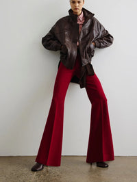 Styled view of the SMYTHE Classic Pant in Garnet Fleck worn with a brown leather bomber jacket