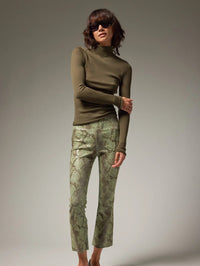 Front view of the SPRWMN Jackie Leather Ankle Flare in Anaconda Green snakeskin on a model