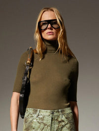 Close front view of the SPRWMN Cashmere Turtleneck in Olive showing the rib knit and lettuce hems