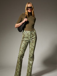 Full length view of the SPRWMN Olive Cashmere Turtleneck tucked into snakeskin pants