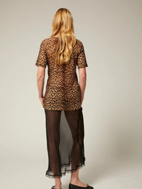 Back view of the SPRWMN Tissue V Neck Tee in Jaguar leopard print over a sheer black skirt