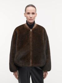 Front view of the STUDIO AR Etta Faux Fur Bomber Jacket in Olive with ribbed collar and front zip