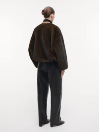 Back view of the STUDIO AR Etta Faux Fur Bomber Jacket in Olive showing the relaxed shape