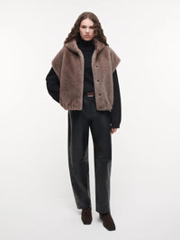 Full length view of the STUDIO AR Olena Faux Fur Gilet in Pebble styled with leather trousers