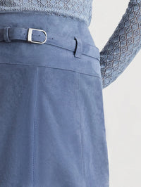 Detail of the silver buckle belt and panel seams on the Tanya Taylor Beacon Skirt in Morning Fog.