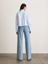Back view of the Tanya Taylor Largaux Top in Oxford Blue showing the cropped hem and back pleat.