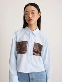 Close up of the sequined front pockets and collar on the Tanya Taylor Largaux Top in Oxford Blue.