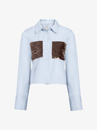 Flat lay of the Tanya Taylor Largaux Top in Oxford Blue, a cropped poplin shirt with sequin pockets.