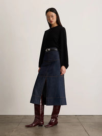 Angled side view of the Tanya Taylor Marina Cashmere Sweater in black showing the full balloon sleeves.