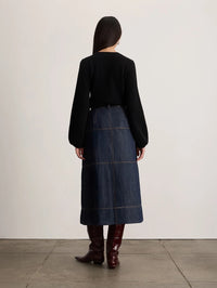 Back view of the Tanya Taylor Marina Cashmere Sweater in black with gathered balloon sleeve cuffs.