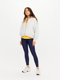 Front view of the Jude Crop Hoodie in Grey Marle by THE UPSIDE, styled with yellow top and navy leggings