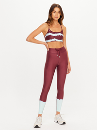 Front view of the Rio Badu Crossback Bra in Tie Dye Rio by THE UPSIDE, styled with matching leggings