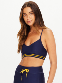 Front view of the Salvador Zoe Bra in navy with yellow stripe detail by THE UPSIDE