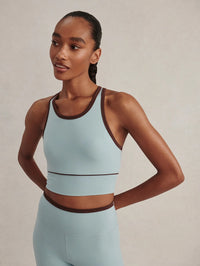 Front close-up of the Varley Always Jay Bra in Tourmaline showing the high neck and contrast piping