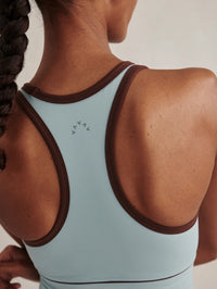 Racerback detail of the Varley Always Jay Bra in Tourmaline with contrast piping and logo