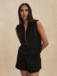 Front view of the Beau Sleeveless Half Zip in black by VARLEY, paired with matching shorts