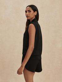 Side view of the Beau Sleeveless Half Zip in black by VARLEY