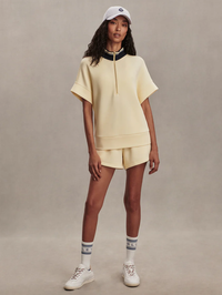Front view of the Ritchie Short Sleeve Sweat 2.0 in Anise Flower by VARLEY, styled with white sneakers
