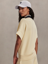 Side view of the Ritchie Short Sleeve Sweat 2.0 in Anise Flower by VARLEY, styled with a white cap