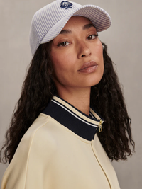 Side view of the Ritchie Short Sleeve Sweat 2.0 in Anise Flower by VARLEY, styled with a striped baseball cap