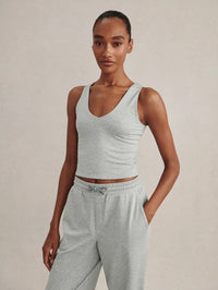 Front view of the Varley Ruby Cropped Tank in Blue Green Marl with a V-neckline, worn with matching joggers