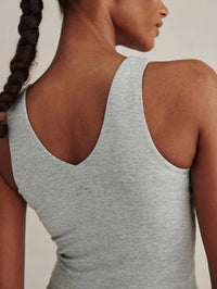 Close-up of the V-back and small logo on the Varley Ruby Cropped Tank in Blue Green Marl heathered jersey