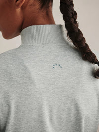 Back logo detail of the Varley Rufus Cropped Zip-Through Sweat in Blue Green Marl