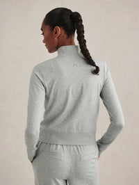 Back view of the Varley Rufus Cropped Zip-Through Sweat in Blue Green Marl showing the cropped hem