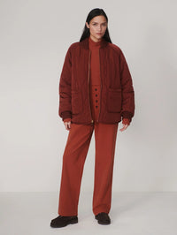 Full-length front view of the Varley Serina Reversible Quilt Jacket in Cherry Mahogany, quilted side
