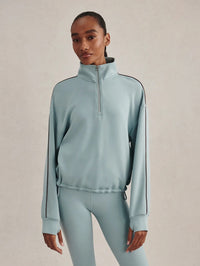 Front view of the Varley Sian Piped Half-Zip Sweat in Tourmaline with drawcord hem