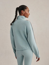 Back view of the Varley Sian Piped Half-Zip Sweat in Tourmaline showing the yoke seam