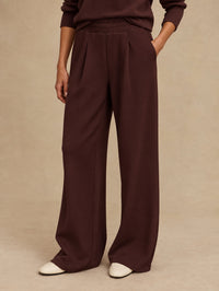 Front view of the Extra Wide Leg Pant in Deep Mahogany by Varley, styled with white sneakers