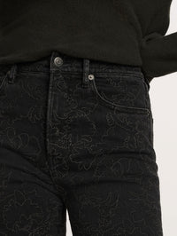 Detail of the front pockets and floral embroidery on the Veronica Beard Beverly Embroidered Skinny-Flare Jean in Washed Onyx